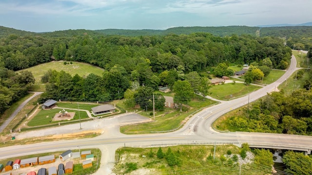 drone / aerial view featuring a wooded view