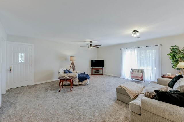 living room with light carpet and ceiling fan