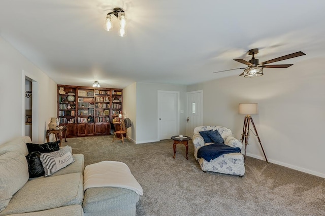 carpeted living area featuring baseboards and ceiling fan