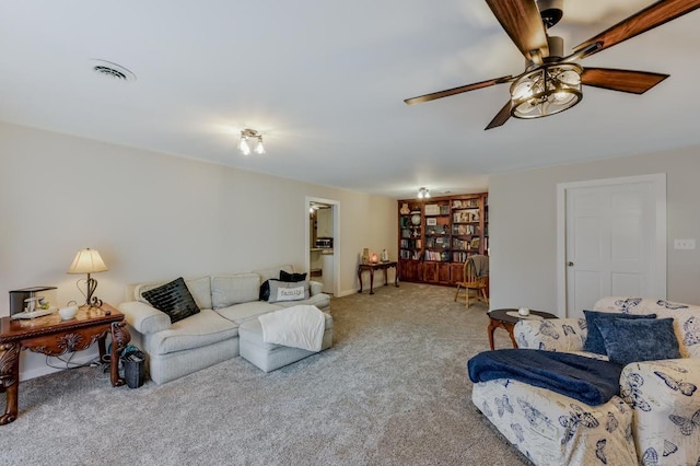 carpeted living room with visible vents and ceiling fan