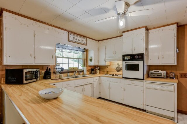 kitchen featuring white cabinets, white appliances, ornamental molding, and ceiling fan