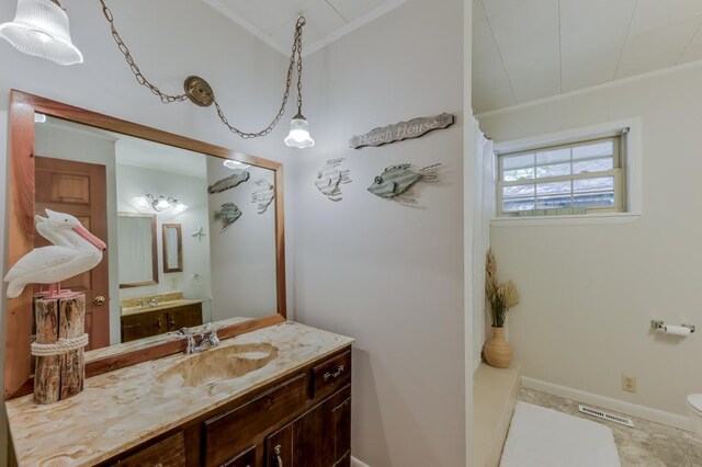 bathroom featuring crown molding and vanity