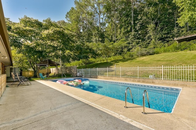 view of pool featuring a patio, a fenced in pool, a yard, a fenced backyard, and a gazebo