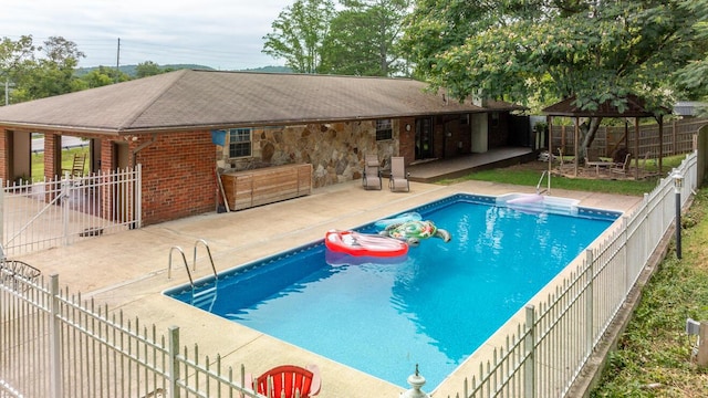 view of pool with a gazebo, a fenced backyard, a fenced in pool, and a patio