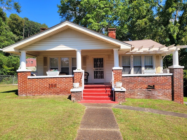 bungalow-style house with a front lawn, a pergola, and covered porch