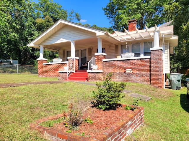 view of front of home with a porch and a front lawn