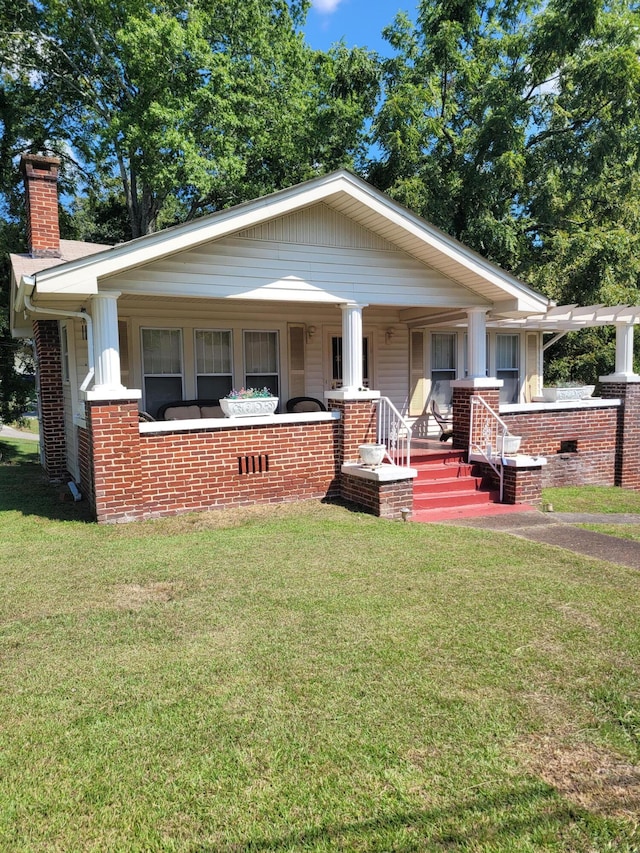 view of front of home featuring a porch and a front lawn