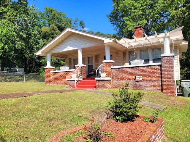 view of front of house featuring a front yard and a porch