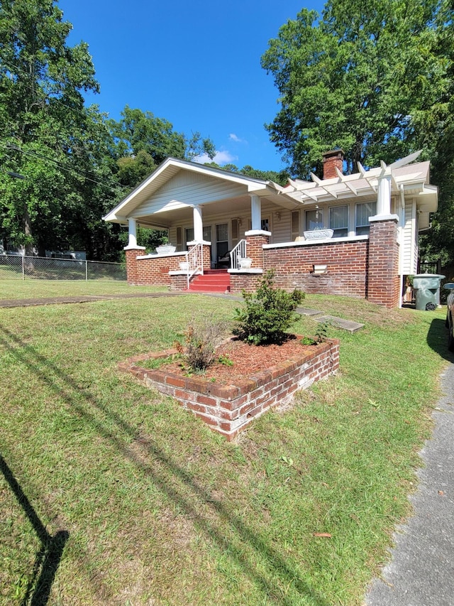 view of front of property with a front yard and a porch