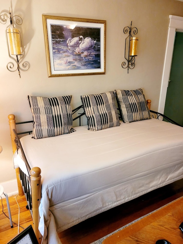 bedroom with hardwood / wood-style flooring