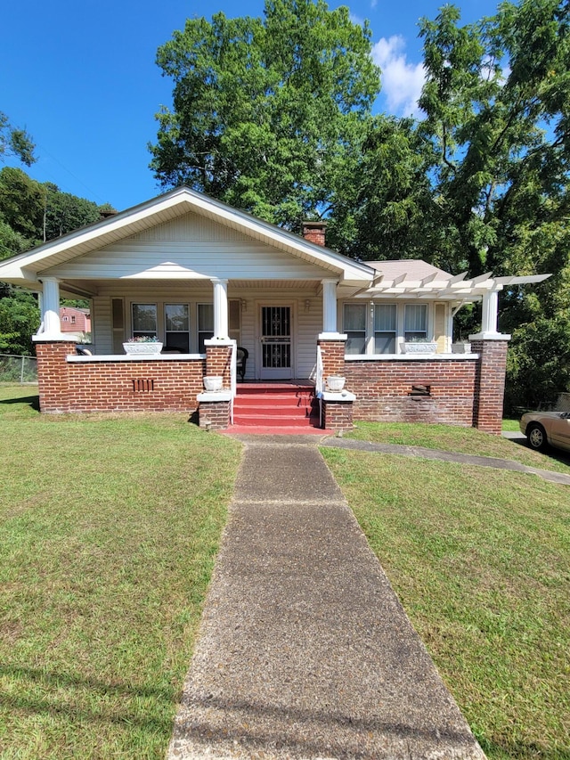 view of front of home featuring covered porch and a front yard