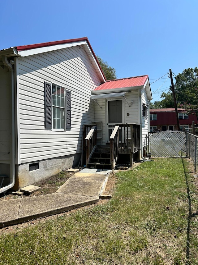 rear view of house featuring a lawn