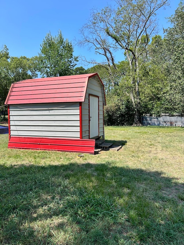 view of outdoor structure featuring a lawn