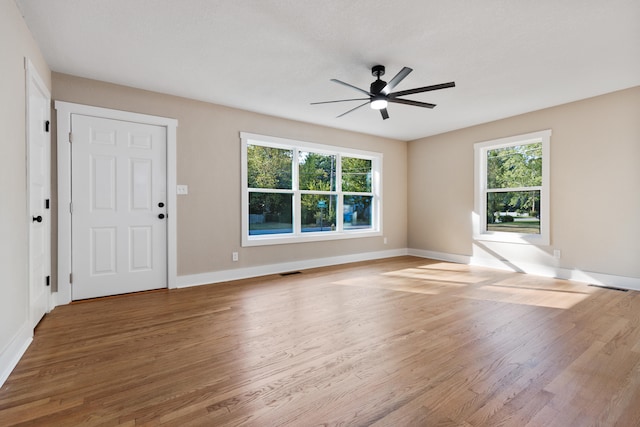 interior space featuring a wealth of natural light, ceiling fan, and hardwood / wood-style floors