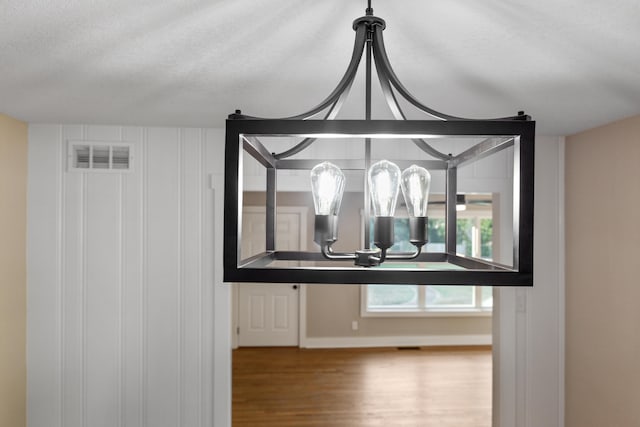 interior details featuring a textured ceiling and hardwood / wood-style flooring