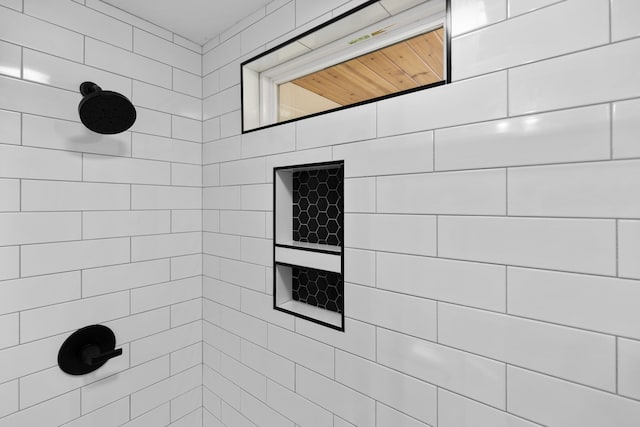 bathroom with tiled shower