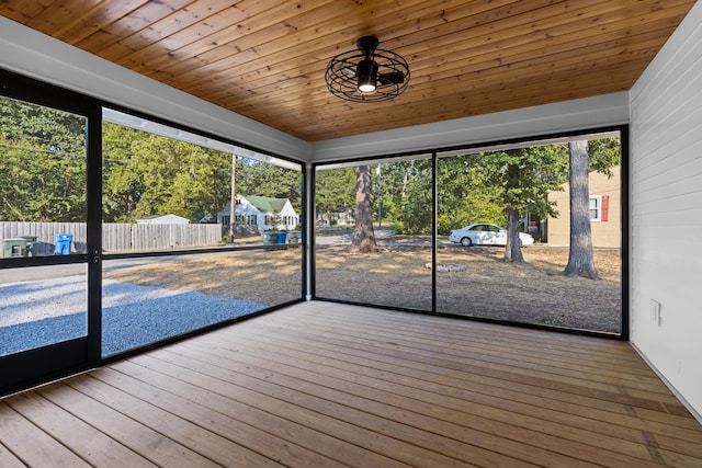 unfurnished sunroom with a wealth of natural light and wooden ceiling