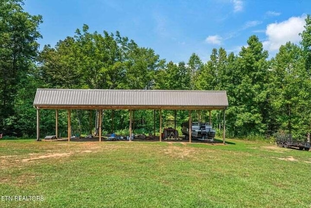 view of property's community with a detached carport and a lawn