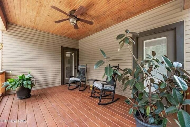 wooden deck with a ceiling fan