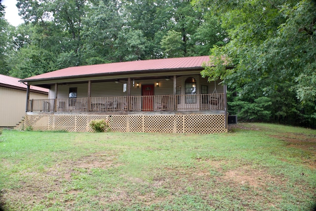 view of front of home featuring a front yard and a deck