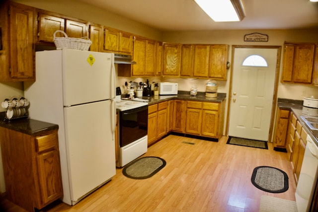 kitchen featuring white appliances and light hardwood / wood-style floors