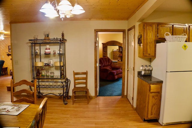 dining area with wood ceiling, ceiling fan with notable chandelier, and light hardwood / wood-style floors