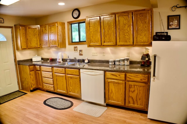 kitchen featuring light wood-type flooring, sink, and white appliances