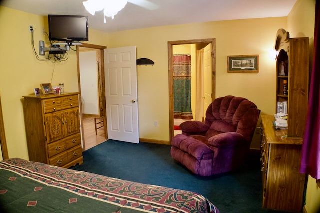 carpeted bedroom featuring ceiling fan and connected bathroom