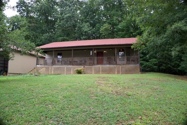 exterior space featuring a wooden deck, a front lawn, and a storage unit