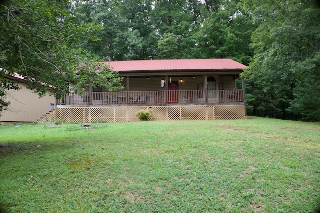 exterior space with a deck and a front lawn