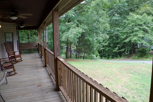 deck with a yard and ceiling fan