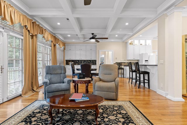 living room with light hardwood / wood-style flooring, ceiling fan, coffered ceiling, and beam ceiling