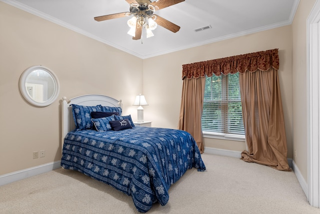 bedroom with ceiling fan, ornamental molding, and carpet floors