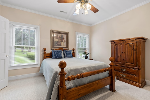 bedroom with ceiling fan, light carpet, and ornamental molding