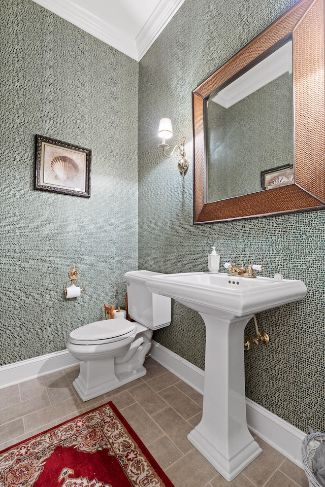 bathroom featuring tile patterned floors, toilet, and ornamental molding