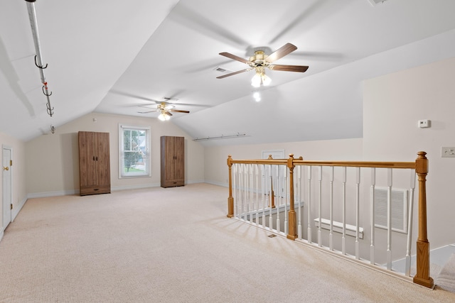 additional living space with lofted ceiling, ceiling fan, and light carpet