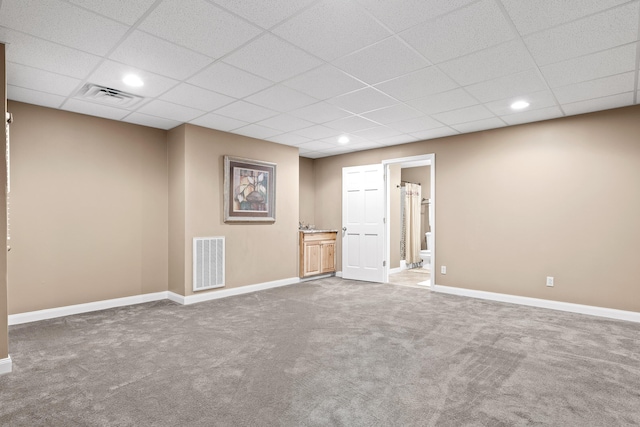 empty room with carpet floors and a drop ceiling