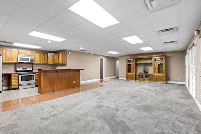 kitchen featuring light colored carpet, a paneled ceiling, and electric stove