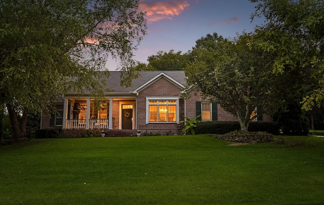 view of front facade with a yard and covered porch