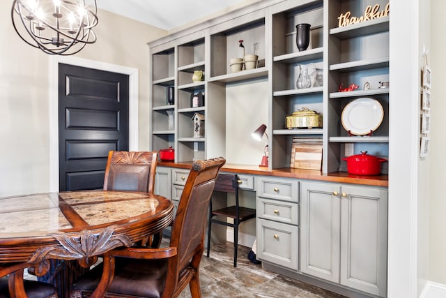 interior space with built in desk and a notable chandelier