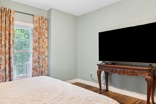 bedroom with dark hardwood / wood-style floors