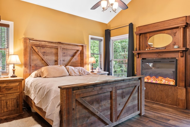 bedroom with lofted ceiling, dark hardwood / wood-style flooring, and ceiling fan