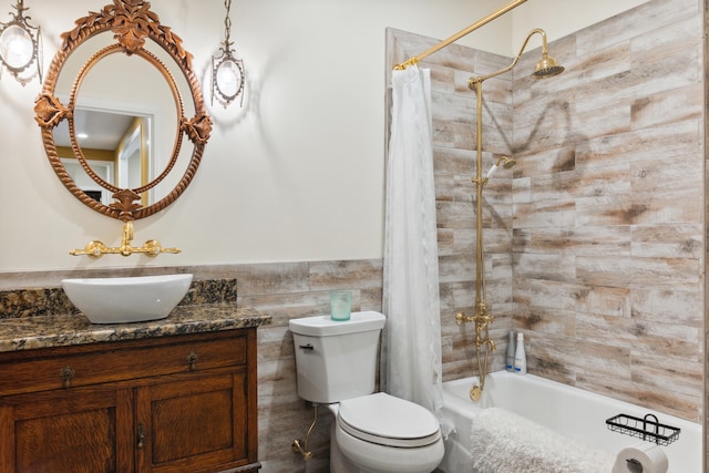 full bathroom with tile walls, toilet, shower / tub combo with curtain, and vanity