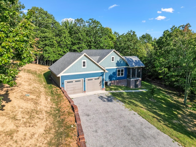 view of front of home featuring a garage and a front lawn