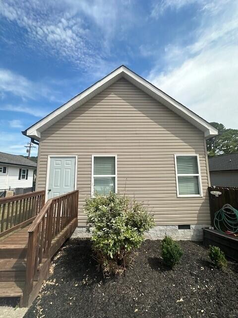 back of property featuring a wooden deck