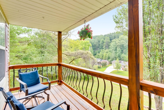 wooden deck featuring a yard