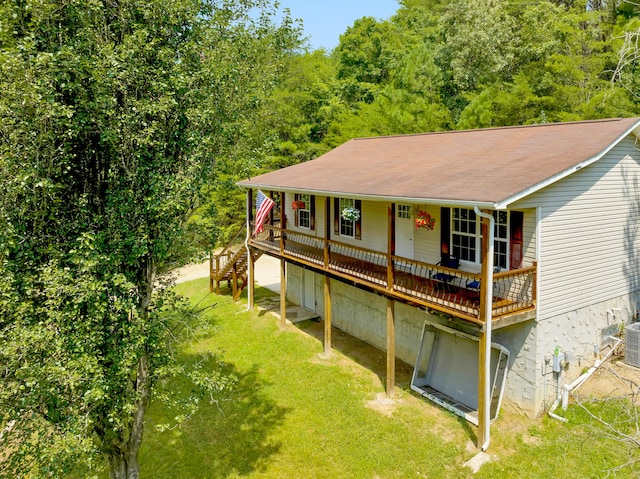 exterior space with cooling unit and a front yard