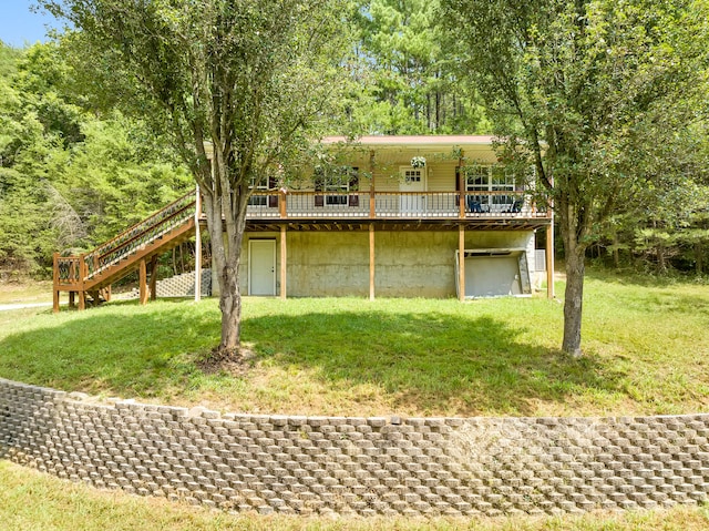 back of property with a wooden deck and a yard