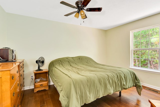 bedroom with dark wood-type flooring and ceiling fan