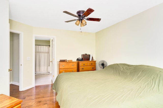 bedroom featuring ceiling fan, hardwood / wood-style flooring, and connected bathroom